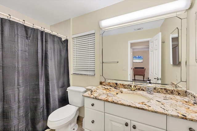 bathroom with toilet and vanity