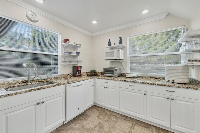 kitchen with white cabinetry, white appliances, crown molding, light stone counters, and sink