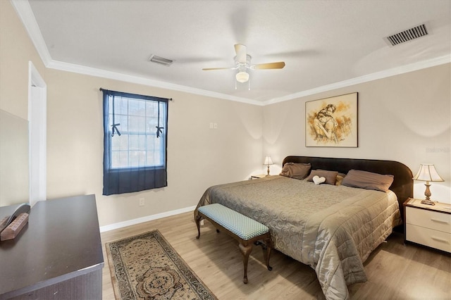 bedroom with ceiling fan, light wood-type flooring, and crown molding