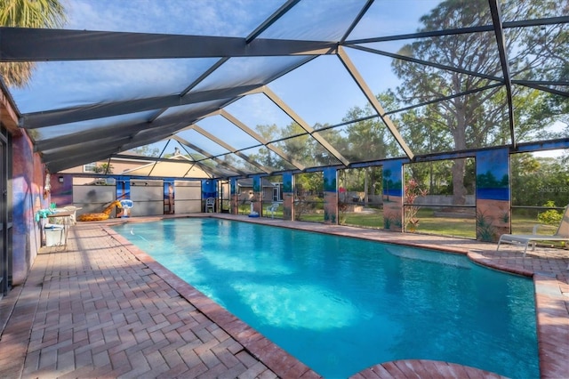 view of swimming pool featuring glass enclosure and a patio