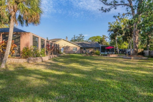 view of yard with a lanai