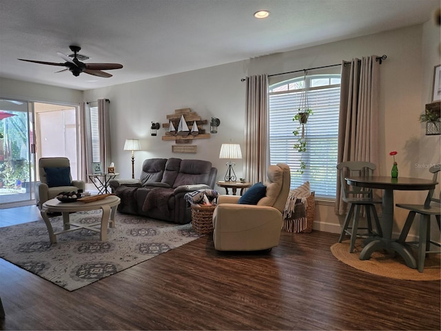 living room featuring dark hardwood / wood-style flooring and ceiling fan