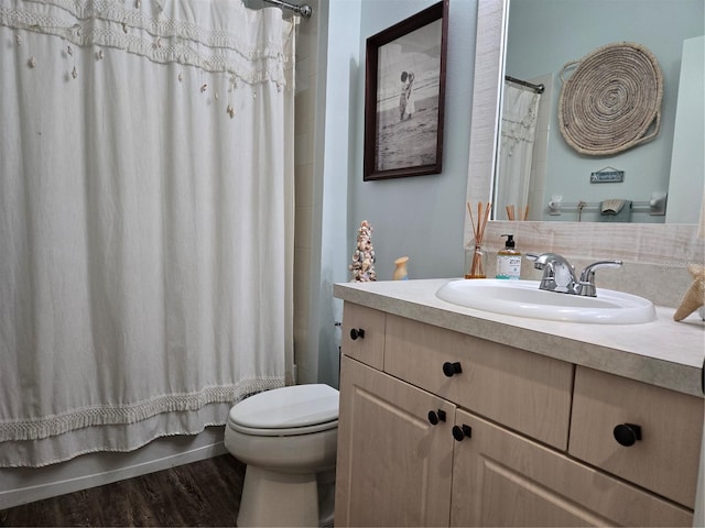 full bathroom featuring wood-type flooring, vanity, toilet, and shower / bath combo with shower curtain