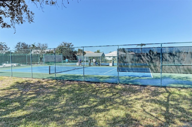 view of sport court featuring a lawn