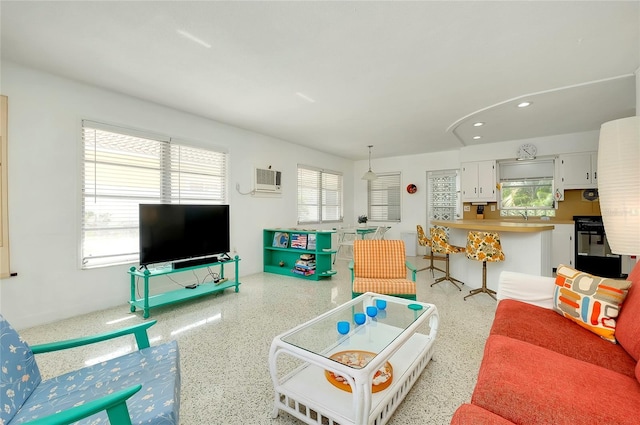 living room featuring an AC wall unit