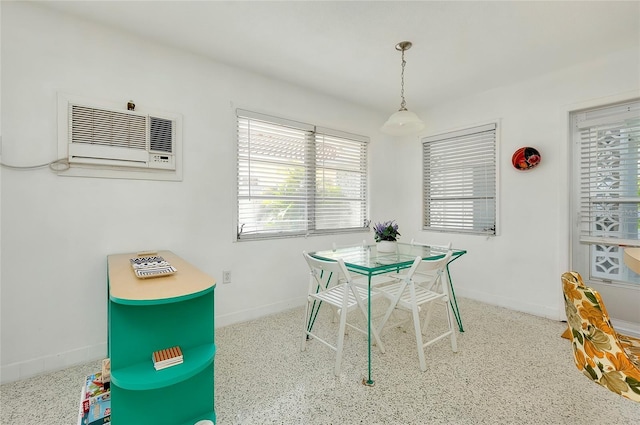 dining room with an AC wall unit