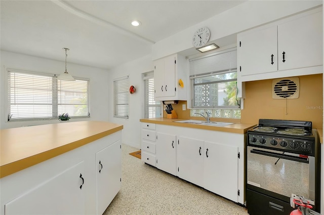 kitchen with black / electric stove, decorative light fixtures, sink, and white cabinets