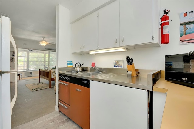 kitchen with white fridge, sink, white cabinets, and ceiling fan