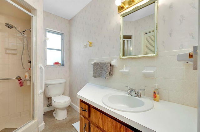 bathroom featuring vanity, tile walls, walk in shower, and toilet