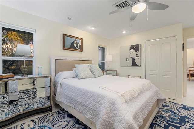 bedroom featuring tile patterned floors, a closet, and ceiling fan