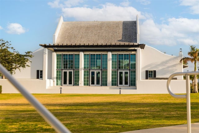 rear view of property featuring a yard and french doors