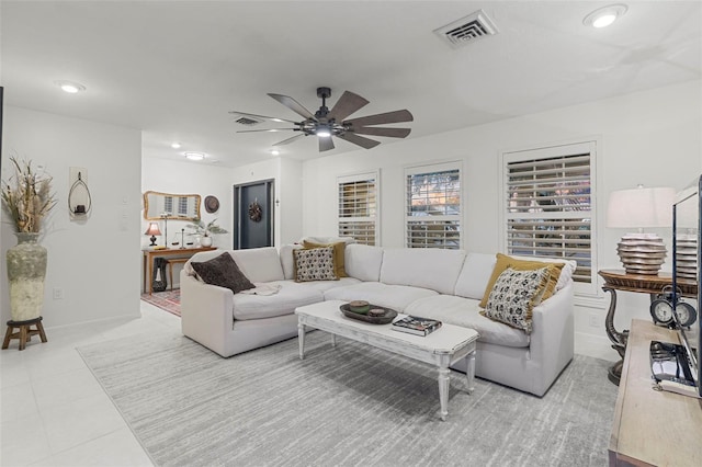 tiled living room with ceiling fan