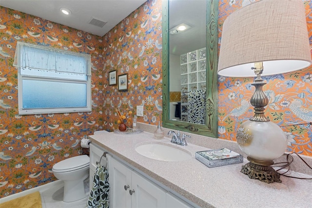 bathroom with vanity, tile patterned floors, and toilet