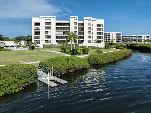 dock area with a lawn and a water view