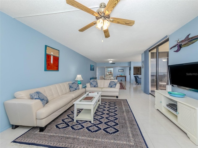 tiled living room with floor to ceiling windows, ceiling fan, and a textured ceiling