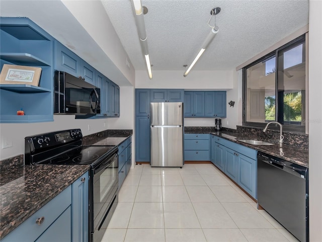 kitchen featuring black appliances, blue cabinetry, dark stone counters, a textured ceiling, and sink