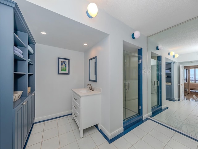 interior space featuring tile patterned flooring, vanity, a textured ceiling, built in features, and an enclosed shower