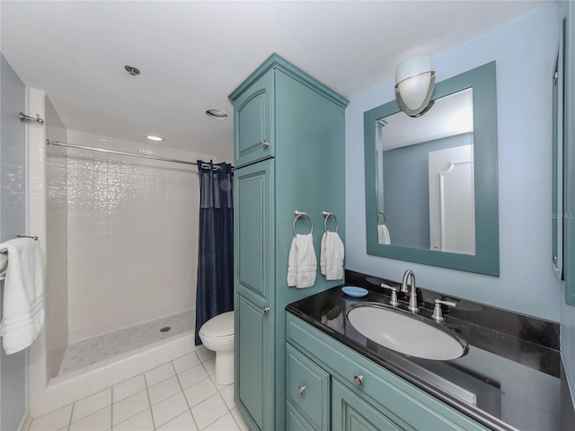 bathroom featuring curtained shower, tile patterned flooring, vanity, and toilet