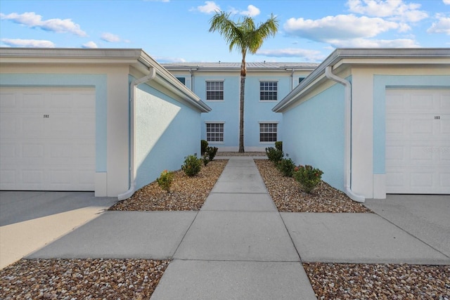 doorway to property with a garage