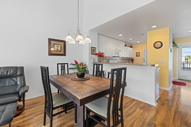 dining room with a chandelier and light hardwood / wood-style flooring