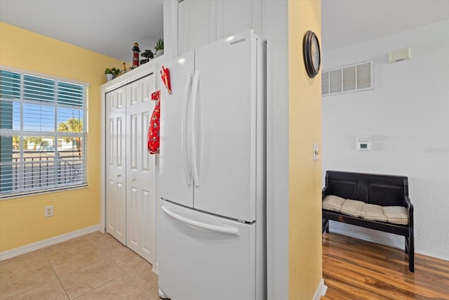 laundry area with light tile patterned floors