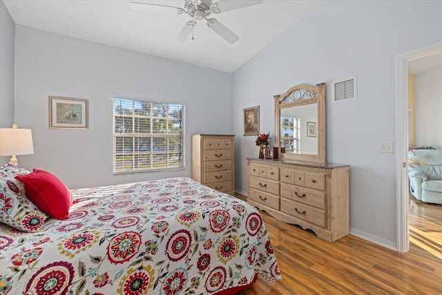 bedroom featuring ceiling fan, light hardwood / wood-style floors, and lofted ceiling