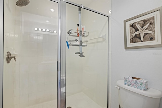 bathroom with an enclosed shower and toilet