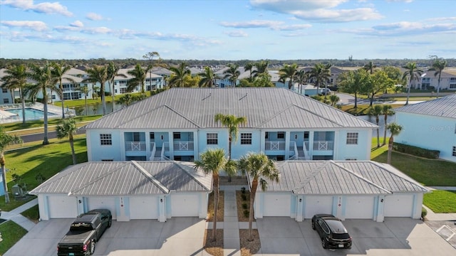 view of front of property featuring a balcony and a garage