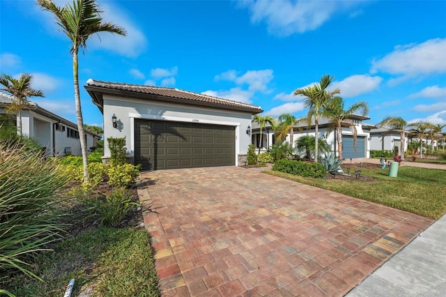 mediterranean / spanish house featuring a garage and a front lawn