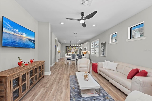 living room with ceiling fan and light hardwood / wood-style floors