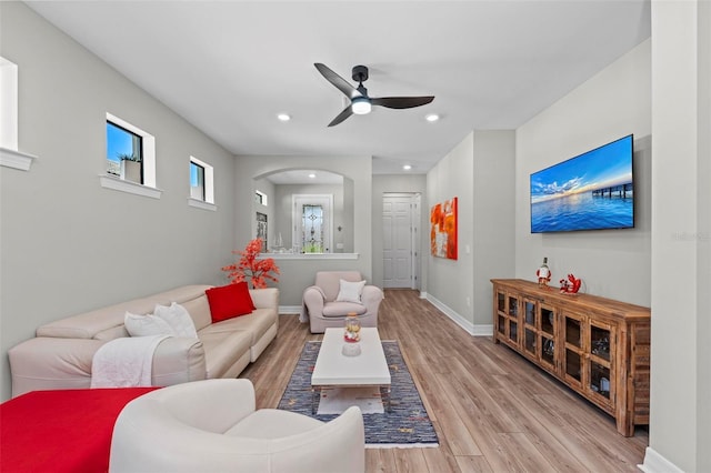 living room featuring ceiling fan and light hardwood / wood-style flooring