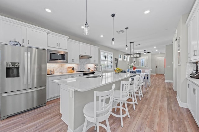 kitchen featuring white cabinets, stainless steel appliances, and sink