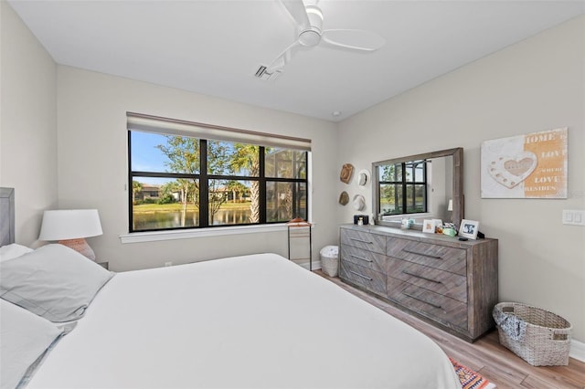 bedroom with ceiling fan and light hardwood / wood-style flooring