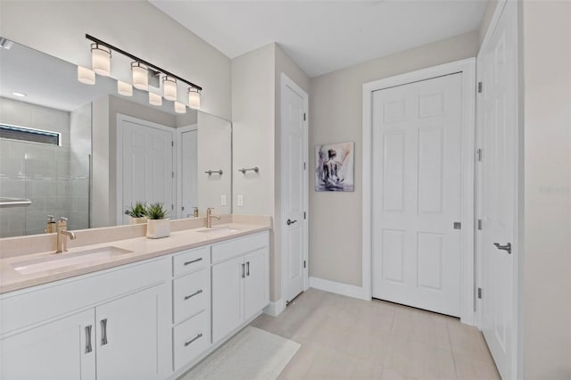 bathroom with a shower with door and vanity