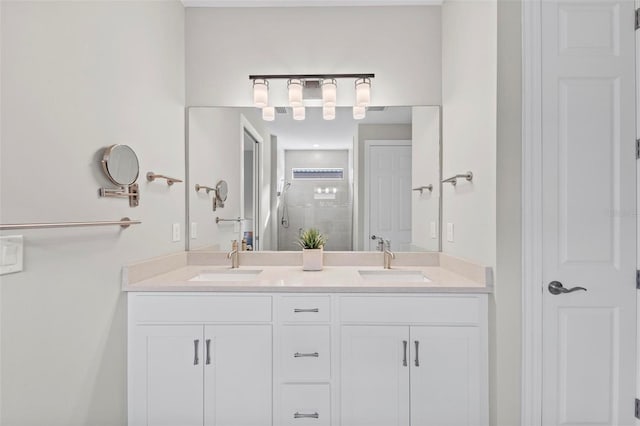 bathroom with vanity and a shower with door