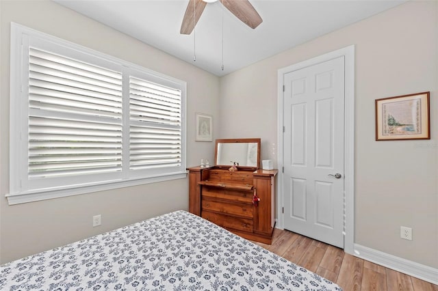 bedroom with ceiling fan and light hardwood / wood-style flooring