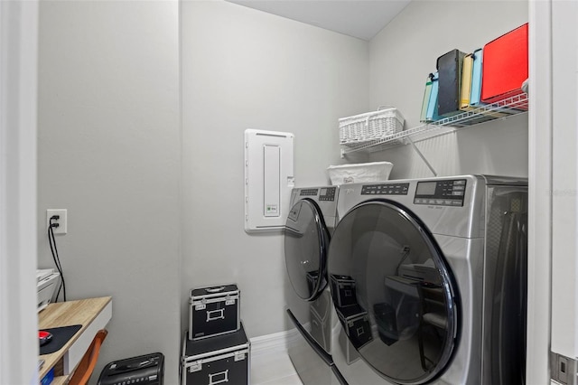 laundry room with separate washer and dryer and light tile patterned floors