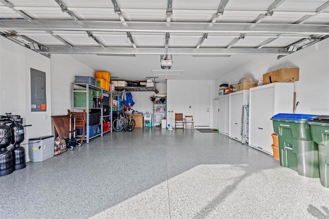 garage featuring electric panel and a garage door opener