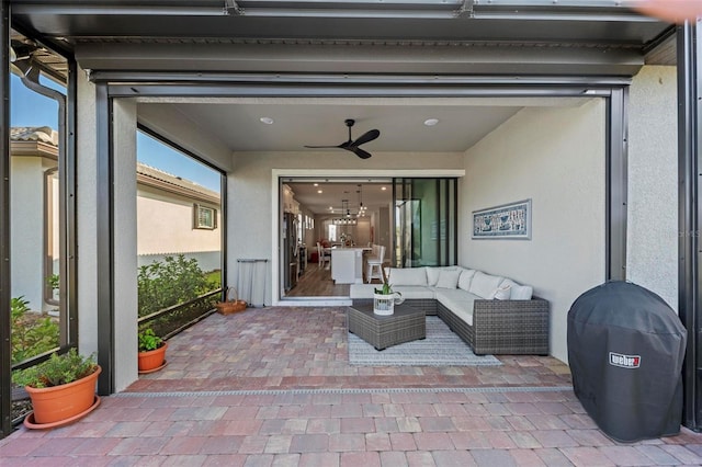 view of patio / terrace featuring ceiling fan and an outdoor living space