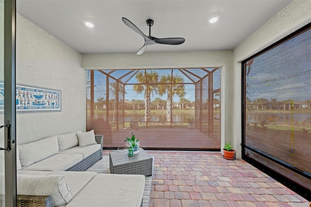 sunroom featuring ceiling fan