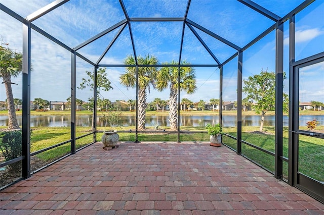 unfurnished sunroom with a water view