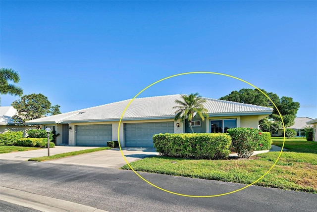 ranch-style home with a garage and a front lawn