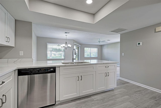 kitchen with white cabinetry, sink, stainless steel dishwasher, light stone countertops, and light hardwood / wood-style flooring