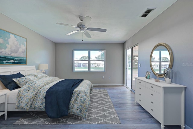 bedroom featuring dark wood-type flooring, ceiling fan, and access to outside