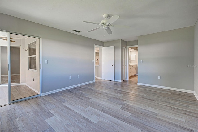 unfurnished bedroom featuring light hardwood / wood-style floors, ceiling fan, and a closet