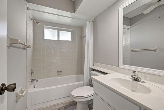 full bathroom with shower / tub combo with curtain, vanity, hardwood / wood-style flooring, and toilet