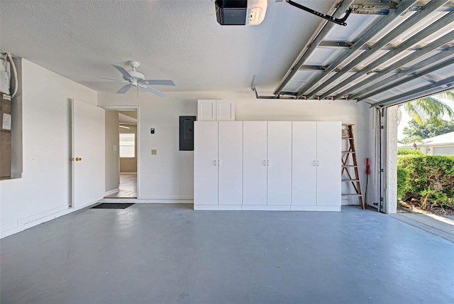 garage featuring ceiling fan, a garage door opener, and electric panel