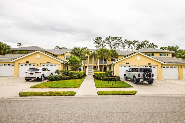 view of front of house with a garage and a front lawn