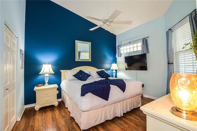 bedroom featuring dark hardwood / wood-style floors, a closet, and ceiling fan