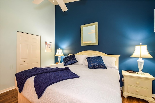 bedroom with a closet, ceiling fan, and dark hardwood / wood-style floors